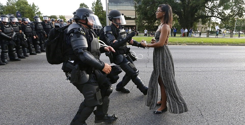 woman facing several police